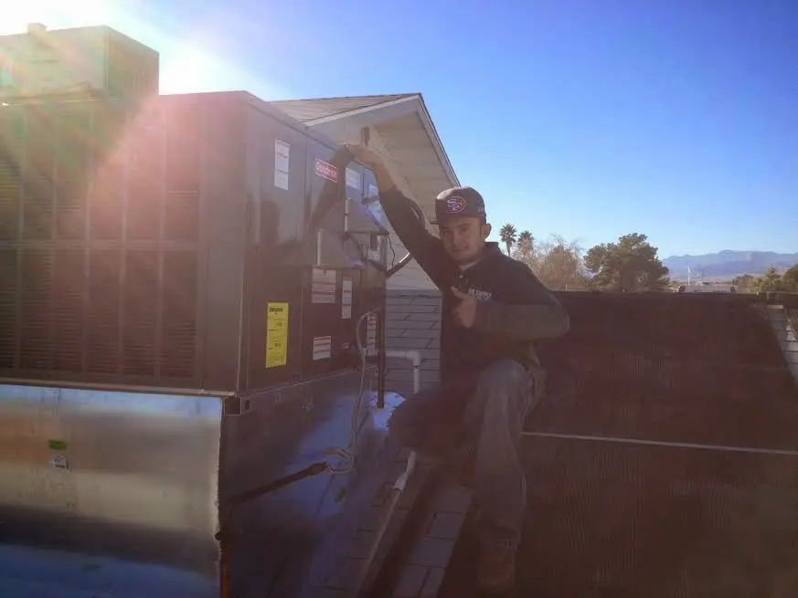 HVAC technician performing HVAC Inspection on a rooftop unit in San Diego